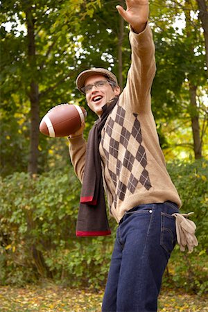 football season - Portrait of Man Throwing American Football, in Autumn Stock Photo - Premium Royalty-Free, Code: 600-01717661