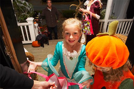 Portrait of Girl and other Children Trick or Treating at Halloween Stock Photo - Premium Royalty-Free, Code: 600-01717707