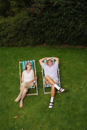 senior folding chair - Couple Sitting in Lawn Chairs Stock Photo - Premium Royalty-Free, Code: 600-01717987