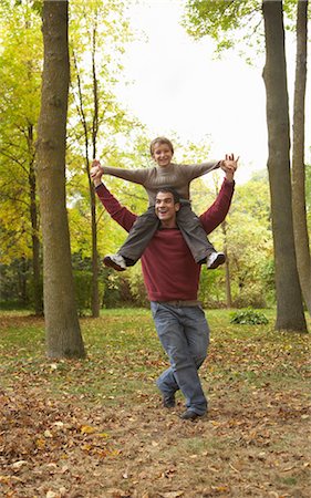 simsearch:600-01717666,k - Son Riding on Father's Shoulders Stock Photo - Premium Royalty-Free, Code: 600-01742511