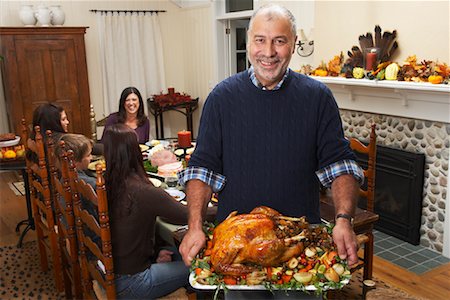 family meal grandparents - Man Holding Thanksgiving Turkey Stock Photo - Premium Royalty-Free, Code: 600-01742538