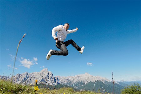 Man Jumping by Mountain Range Stock Photo - Premium Royalty-Free, Code: 600-01742563