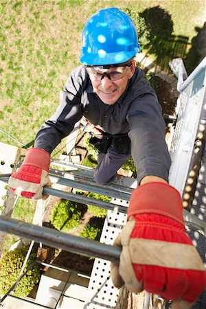simsearch:600-01742614,k - Construction Worker Climbing Scaffold Stock Photo - Premium Royalty-Free, Code: 600-01742657