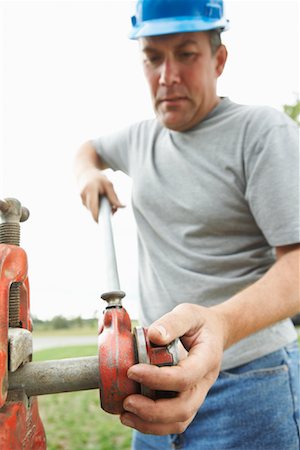 simsearch:600-01742614,k - Construction Worker Threading Pipe Stock Photo - Premium Royalty-Free, Code: 600-01742671