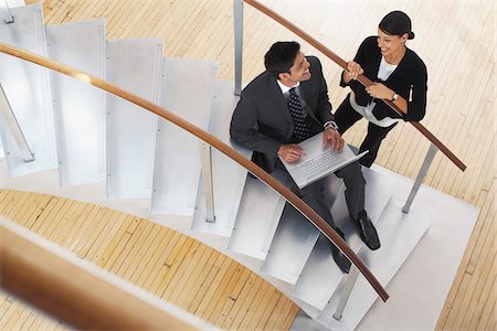 Businessman and Woman on Staircase Stock Photo - Premium Royalty-Free, Code: 600-01753601