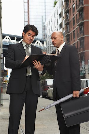 simsearch:700-00281308,k - Businessmen on Sidewalk Looking at Files, New York City, New York, USA Stock Photo - Premium Royalty-Free, Code: 600-01764156