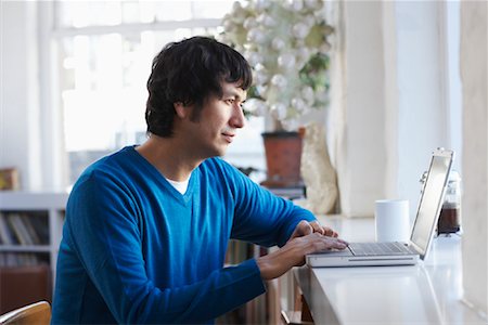 Man Using Laptop Computer Stock Photo - Premium Royalty-Free, Code: 600-01764654