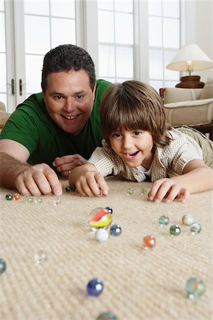 family games - Father and Son Playing With Marbles Stock Photo - Premium Royalty-Free, Code: 600-01787579