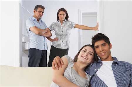 Portrait of Couple, Angry Parents in Background Stock Photo - Premium Royalty-Free, Code: 600-01787695