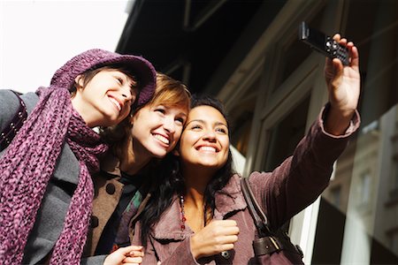 friends silly - Three Woman Taking Picture of Selves with Camera Phone Stock Photo - Premium Royalty-Free, Code: 600-01827667