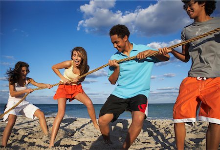 Friends Playing Tug-of-War on Beach Stock Photo - Premium Royalty-Free, Code: 600-01838213