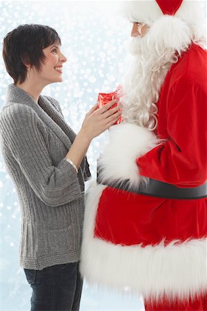 simsearch:600-02046034,k - Santa Giving Present to Woman Stock Photo - Premium Royalty-Free, Code: 600-01838477