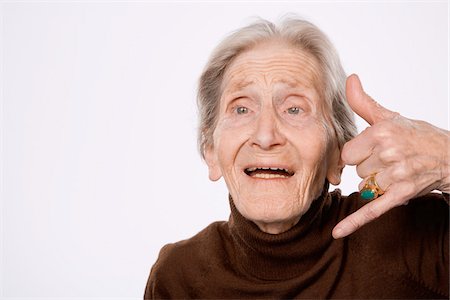 phone one person adult smile elderly - Woman Making Telephone Sign with Hand Stock Photo - Premium Royalty-Free, Code: 600-01879176