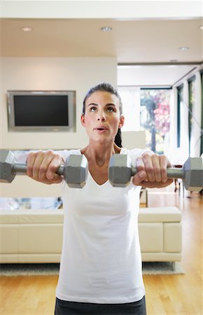 straining (overexertion) - Woman Exercising in Home Foto de stock - Sin royalties Premium, Código: 600-01954795