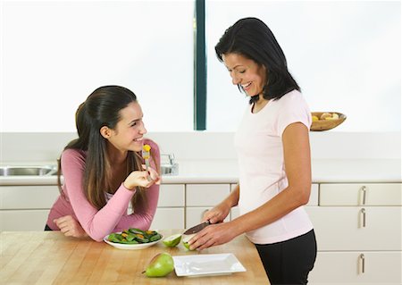 simsearch:700-00551400,k - Woman Eating in Kitchen Stock Photo - Premium Royalty-Free, Code: 600-01954844