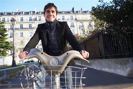 person in a basket of a bike - Man Renting Bicycle, Paris, France Stock Photo - Premium Royalty-Free, Code: 600-01956024