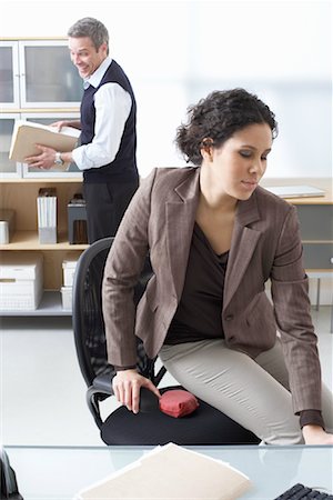 prank - Businessman Playing Practical Joke on Businesswoman Stock Photo - Premium Royalty-Free, Code: 600-02081758