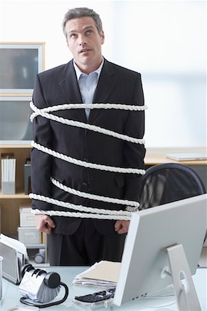 simsearch:400-04041701,k - Businessman Tied Up with Rope at Desk Stock Photo - Premium Royalty-Free, Code: 600-02081769