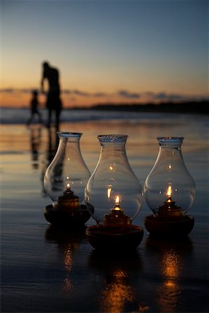 simsearch:600-02121195,k - Oil Lamps on Beach at Sunset, People in Background Stock Photo - Premium Royalty-Free, Code: 600-02121194