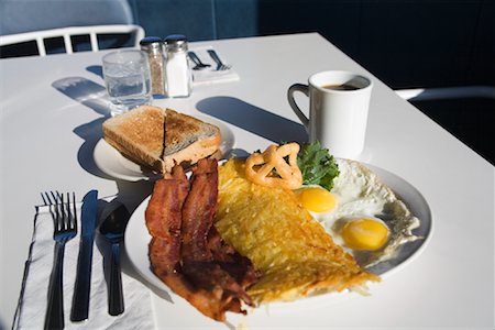 Plate of Bacon and Eggs on Table at Restaurant Stock Photo - Premium Royalty-Free, Code: 600-02130636