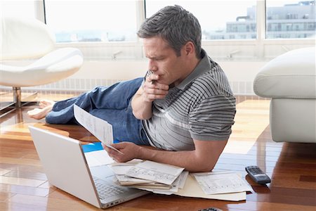 Man with Bills and Laptop Computer Stock Photo - Premium Royalty-Free, Code: 600-02130665