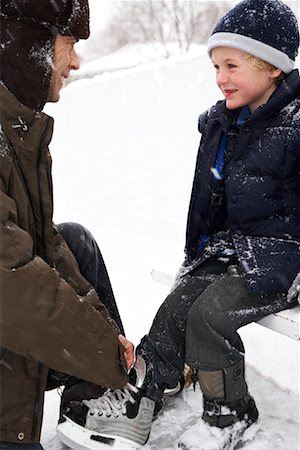 Father Helping Son Put on Skates Stock Photo - Premium Royalty-Free, Code: 600-02200081