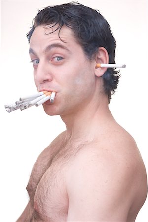 disgust - Man Smoking Many Cigarettes Stock Photo - Premium Royalty-Free, Code: 600-02235840