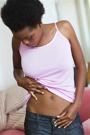 simsearch:600-02245725,k - Woman Looking at Stomach Stock Photo - Premium Royalty-Free, Code: 600-02264733