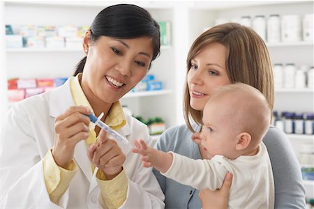 Pharmacist Talking to Mother With Baby Stock Photo - Premium Royalty-Free, Code: 600-02265340