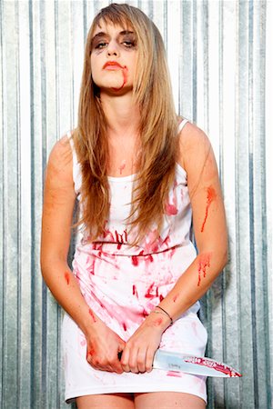 Portrait of Bloodied Woman Carrying a Butcher's Knife Stock Photo - Premium Royalty-Free, Code: 600-02289242