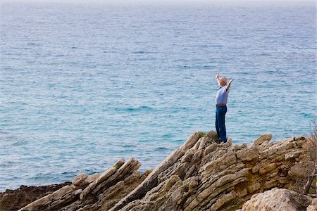 simsearch:700-01163568,k - Man Standing on Cliff Looking Out at Ocean Stock Photo - Premium Royalty-Free, Code: 600-02290069