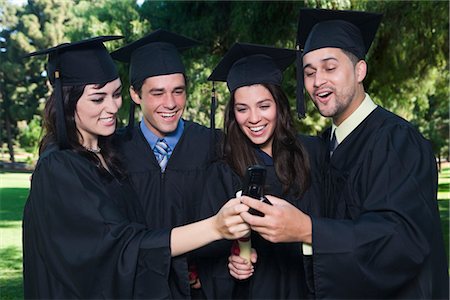 student texting on cell phone - College Graduates with Cellular Phones Stock Photo - Premium Royalty-Free, Code: 600-02312362