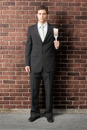 Businessman with Paintbrush by Brick Wall Painting Stock Photo - Premium Royalty-Free, Code: 600-02332687