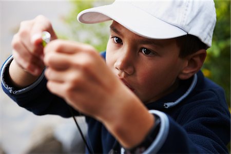 photos of little boy fishing - Boy Putting Lure on Fishing Rod, Algonquin Park, Ontario, Canada Stock Photo - Premium Royalty-Free, Code: 600-02348775