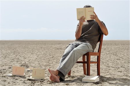 Man Reading Books on the Beach Stock Photo - Premium Royalty-Free, Code: 600-02348798