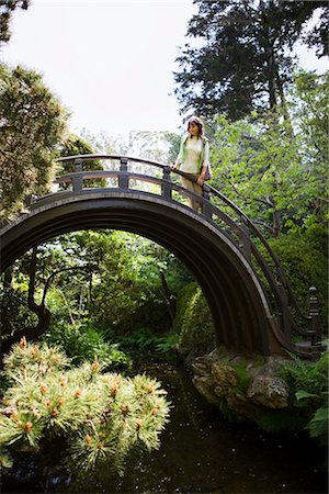 Woman Walking Across Bridge at the Japanese Tea Garden in Golden Gate Park, San Francisco, California, USA Stock Photo - Premium Royalty-Free, Code: 600-02376680