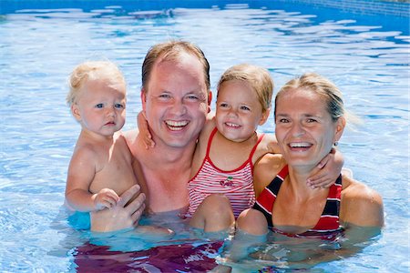 simsearch:700-02724695,k - Family in Swimming Pool Stock Photo - Premium Royalty-Free, Code: 600-02371005