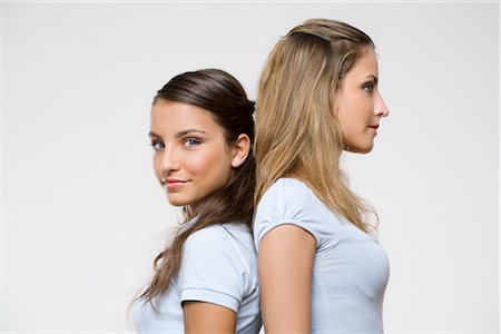 siblings conflict - Teenagers Standing Back to Back Stock Photo - Premium Royalty-Free, Code: 600-02371348