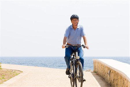 Man Riding Bicycle by Water Stock Photo - Premium Royalty-Free, Code: 600-02428450