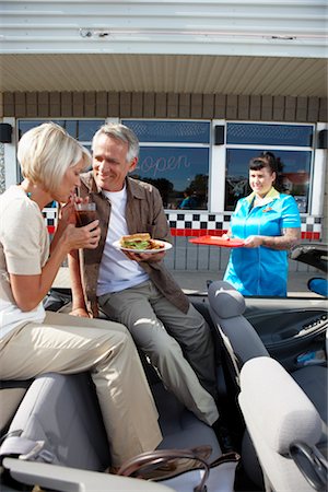 retro diner - Waitress Serving Couple in Their Convertible at a Retro Diner, Niagara Falls, Ontario, Canada Stock Photo - Premium Royalty-Free, Code: 600-02429037