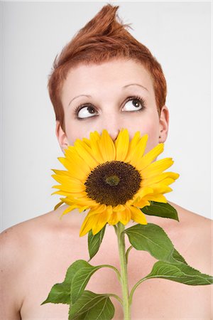 simsearch:600-03018098,k - Portrait of Woman Smelling a Sunflower Stock Photo - Premium Royalty-Free, Code: 600-02504709