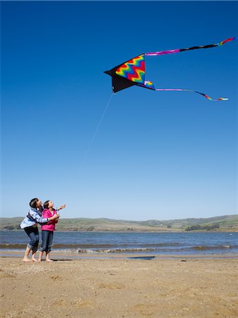 parent child kite - Mother and Daughter Flying Kite on Beach Stock Photo - Premium Royalty-Free, Code: 600-02637664