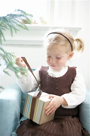 Little Girl Opening Present Stock Photo - Premium Royalty-Free, Code: 600-02645634
