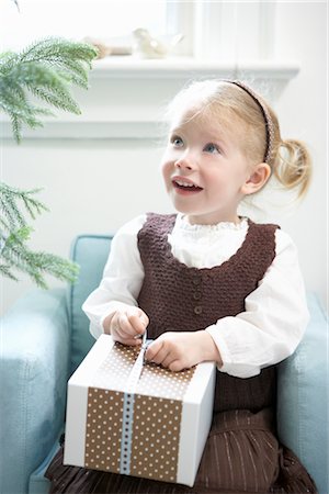 Little Girl Opening Present Stock Photo - Premium Royalty-Free, Code: 600-02645633