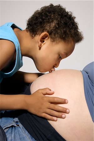 Boy Kissing Pregnant Mother's Stomach Stock Photo - Premium Royalty-Free, Code: 600-02660009