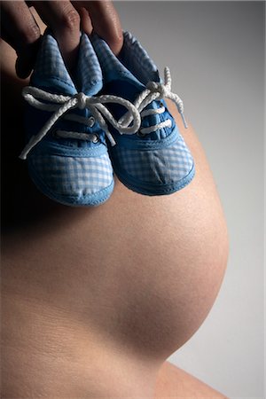 Woman Holding Baby's Shoes Stock Photo - Premium Royalty-Free, Code: 600-02660035