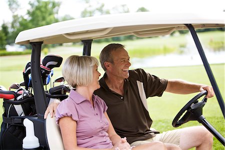 Couple Driving Golf Cart, Burlington, Ontario, Canada Stock Photo - Premium Royalty-Free, Code: 600-02670420