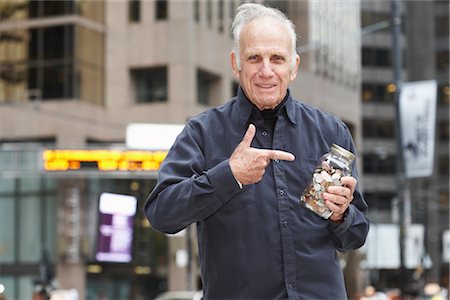devalue - Portrait of Man Holding Jar of Coins Stock Photo - Premium Royalty-Free, Code: 600-02670662