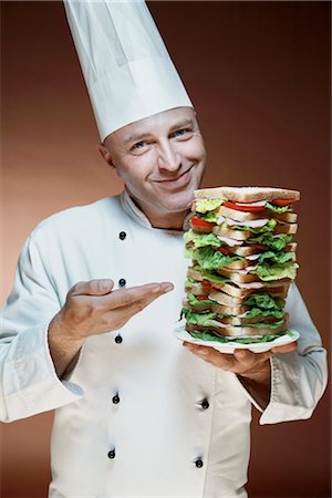 Chef Holding Plate with Big Sandwich Stock Photo - Premium Royalty-Free, Code: 600-02670684