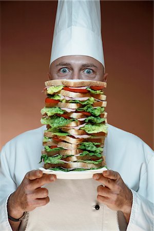 Chef Holding Plate with Big Sandwich Stock Photo - Premium Royalty-Free, Code: 600-02670682